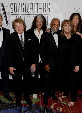 (l to r) Inductee Holly Knight, SHOF Chairman Jimmy Webb, Inductees JD Souther,  Mick Jones, Lou Gramm & Joe Perry, Pioneer Award honoree Berry Gordy, SHOF President/CEO Linda Moran, Inductee Steven Tyler, Johnny Mercer Award recipient Bernie Taupin,  Inductee Tony Hatch & Hal David Starlight Awardee Benny Blanco 