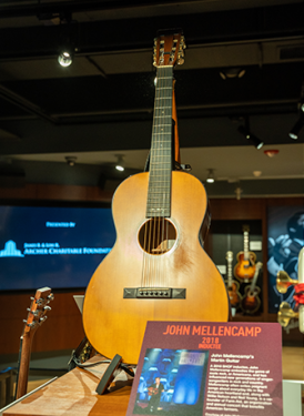 The exhibit includes personal instruments of SHOF Inductees John Mellencamp (above), Bill Withers, Jimmy Jam and Terry Lewis